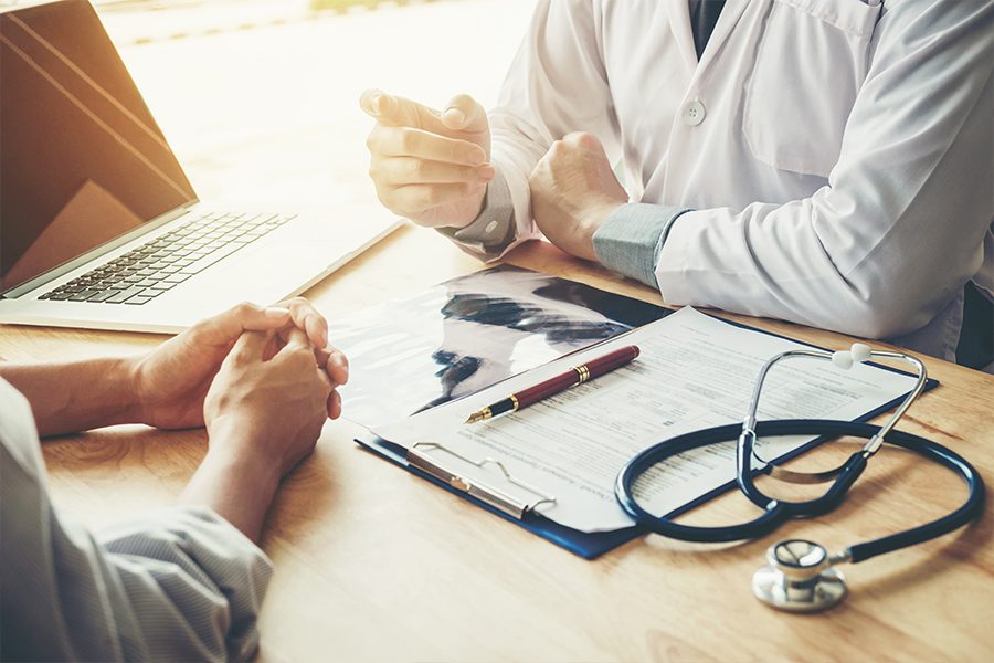 Patient and doctor going over x-ray results